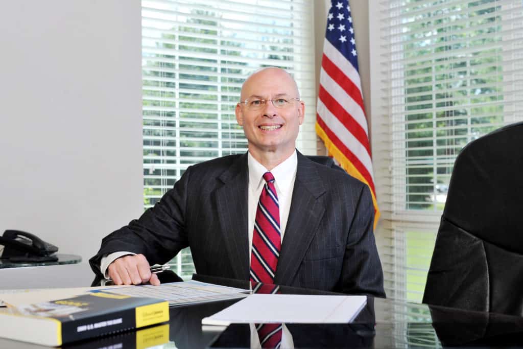 tom dunn sitting with papers