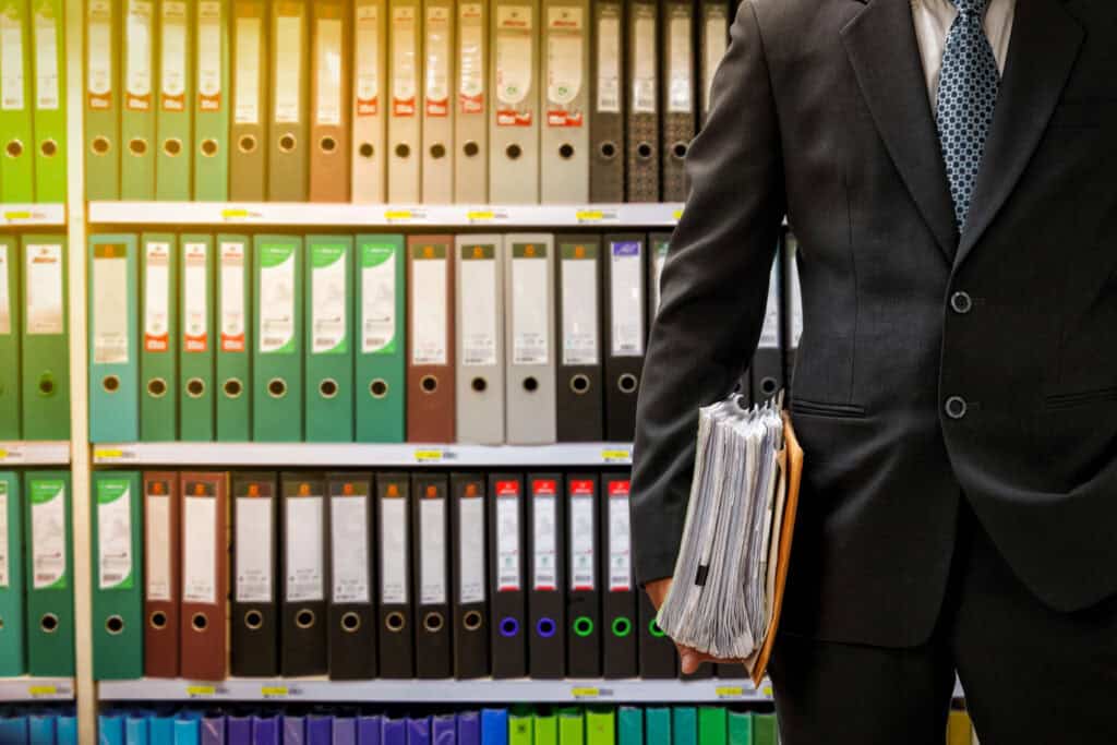 Businessman holding files in office